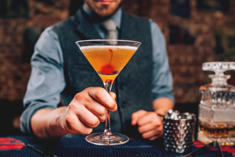 bartender serve manhattan cocktail